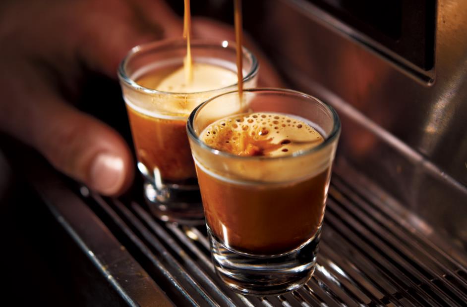 Smiling Starbucks baristas making espresso